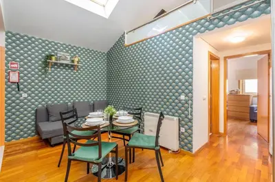 a dining room with a table and chairs at Cedofeita Paradise w parking included in Porto