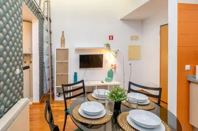 a dining room with a glass table and chairs at Cedofeita Paradise w parking included in Porto
