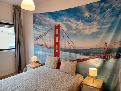 a bedroom with a mural of the golden gate bridge at Oporto Cozy Rooms in Porto