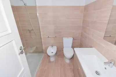 a bathroom with a toilet and a bath tub at Lolla's City House in Porto