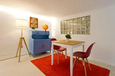a room with a table and two chairs and a desk at Oporto Blue Trindade - Magical Citycenter Apartment in Porto