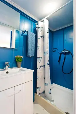 a blue bathroom with a shower and a sink at Oporto Blue Trindade - Magical Citycenter Apartment in Porto