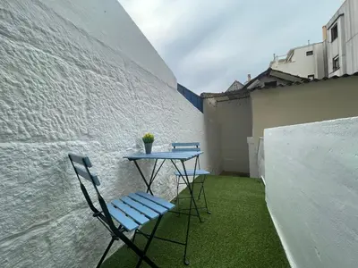 two chairs and a table on a small balcony at Oporto Blue Trindade - Magical Citycenter Apartment in Porto