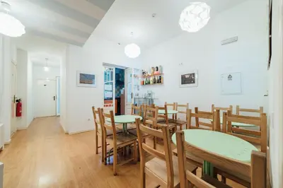 a dining room with wooden tables and chairs at SwissPorto Guest House in Porto