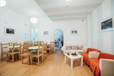 a living room with a couch and a table and chairs at SwissPorto Guest House in Porto