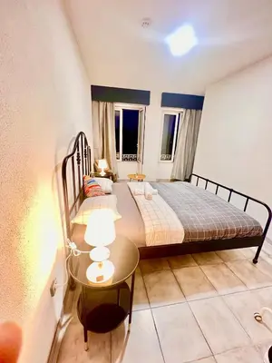 a bedroom with two beds and a table in it at SwissPorto Guest House in Porto