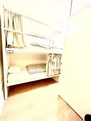 a walk in closet with white shelves at SwissPorto Guest House in Porto