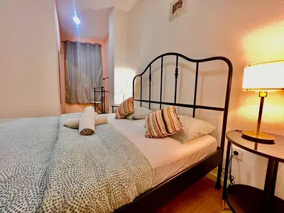 a bedroom with a large bed with pillows on it at SwissPorto Guest House in Porto