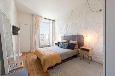 a bedroom with a bed and a large window at Cativo Apartment - Porto Downtown in Porto