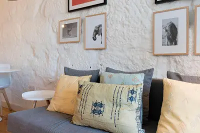 a living room with a blue couch and pictures on the wall at Cativo Apartment - Porto Downtown in Porto