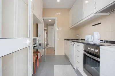 a kitchen with a table and chairs in a room at Liiiving in Porto - Terrace Downtown Apartment in Porto