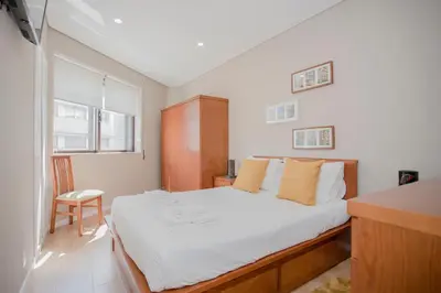 a white bathroom with a toilet and a sink at Liiiving in Porto - Terrace Downtown Apartment in Porto