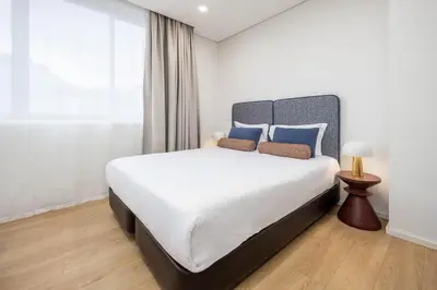 a bedroom with a large bed with towels on it at Aspasios Picaria Apartments in Porto