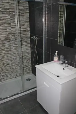 a bathroom with a white sink and a shower at D. Duarte I in Porto