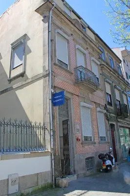 a building with a scooter parked in front of it at D. Duarte I in Porto