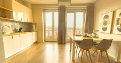 a kitchen with a table and chairs and a dining room at PipaD'oro by YoursPorto in Porto