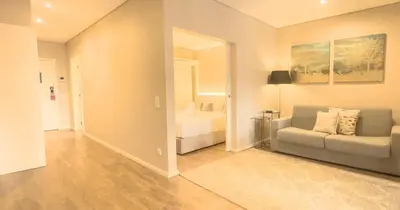 a living room with a couch and a mirror at PipaD'oro by YoursPorto in Porto