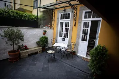 a patio with chairs and a table in front of a building at Domus Duorum in Porto