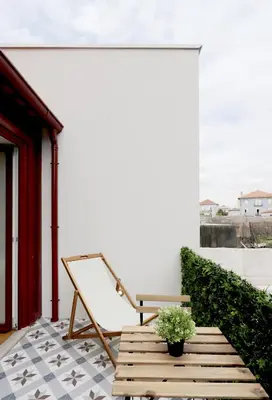 a porch with a bench and a plant on it at HM - Oporto Cedofeita 500C in Porto