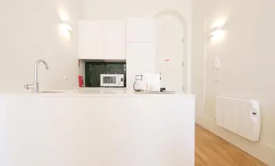 a white kitchen with a counter and a microwave at HM - Oporto Cedofeita 500B in Porto