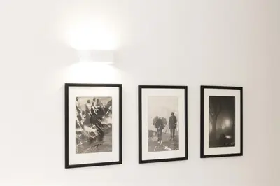 a group of four framed photographs on a wall at HM - Oporto Cedofeita 500E in Porto