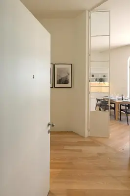 a room with a white door and a dining room at FLH Sá da Bandeira Luxury Apartment in Porto