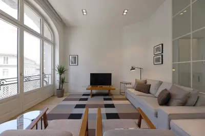 a living room with a couch and a tv at FLH Sá da Bandeira Luxury Apartment in Porto