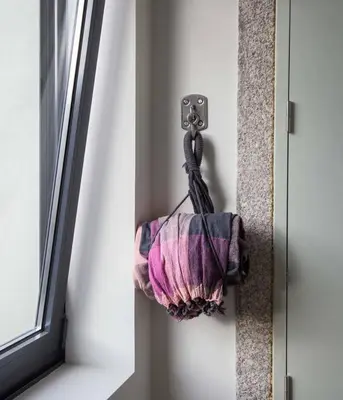 a towel hanging on a wall next to a window at GuestReady - Charming Downtown and Quiet Apartment in Porto