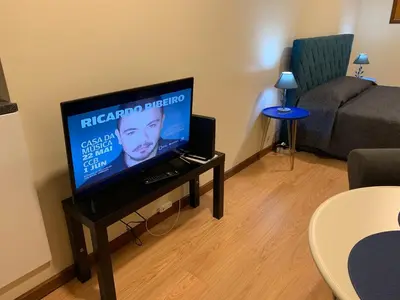 a living room with a flat screen tv on a table at Invicta House Loft Boavista in Porto
