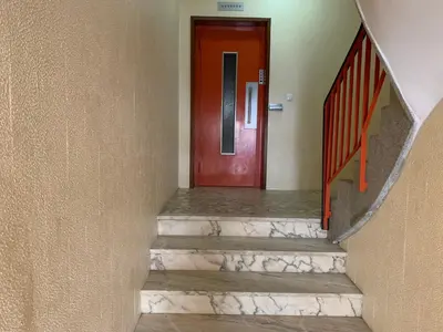 a red door in a hallway with stairs at Invicta House Loft Boavista in Porto