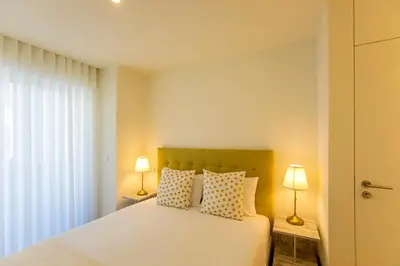 a bedroom with a white bed and two lamps at Casa São Lázaro- Terrace by Oporto Soul in Porto