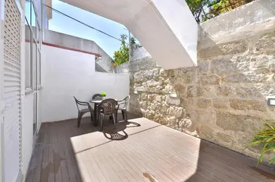 a patio with two chairs and a table on a building at Jardim do Pilar T1 in Vila Nova de Gaia