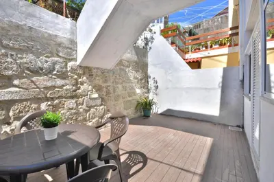 a bathroom with a white sink and a shower at Jardim do Pilar T1 in Vila Nova de Gaia
