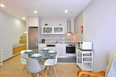 a living room with a tv and a white curtain at Jardim do Pilar T1 in Vila Nova de Gaia