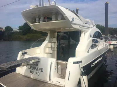 a white boat parked at a dock in the water at Cozy room with lake view in Porto 12 m² and terrace in Porto