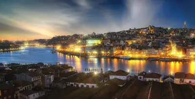 a view of a city at night with a river at Cozy room with lake view in Porto 12 m² and terrace in Porto