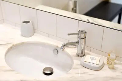 a white sink in a bathroom with aaucet at Oporto Chic&Cozy - Batalha II in Porto