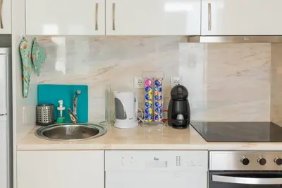 a kitchen with a sink and a counter top at New Bluebell house in heart of Porto in Porto