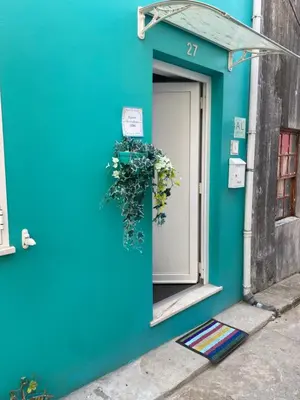 a blue building with a door with a sign on it at New Bluebell house in heart of Porto in Porto