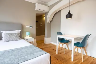 a living room with a table and a tv at MyStay Porto - Urban Collection in Porto