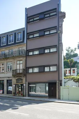 an apartment building on the corner of a street at Signature Apartments Santa Catarina in Porto