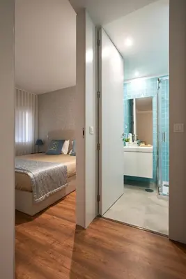 a bedroom with a bed and a bathroom at Signature Apartments Santa Catarina in Porto