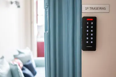 a remote control hanging on a wall next to a window at Jardim de São Lázaro - Porto Apartments in Porto