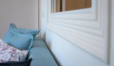 a couch with pillows sitting next to a window at Jardim de São Lázaro - Porto Apartments in Porto