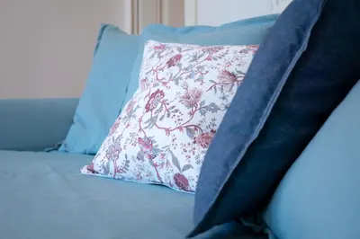 a pillow sitting on top of a blue couch at Jardim de São Lázaro - Porto Apartments in Porto