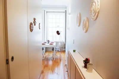 a dining room with a table and a window at Charming Apartment - Free Parking - Heart of the City in Porto