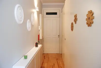 a white bathroom with two sinks and a mirror at Charming Apartment - Free Parking - Heart of the City in Porto