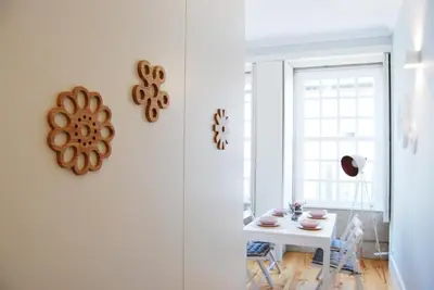 a living room with a gray couch and a table at Charming Apartment - Free Parking - Heart of the City in Porto