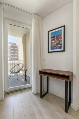 a desk in a room with a view of a balcony at Bra.com Apartments Oporto Faria Guimarães in Porto