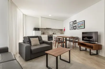 a living room with a couch and a table at Bra.com Apartments Oporto Faria Guimarães in Porto